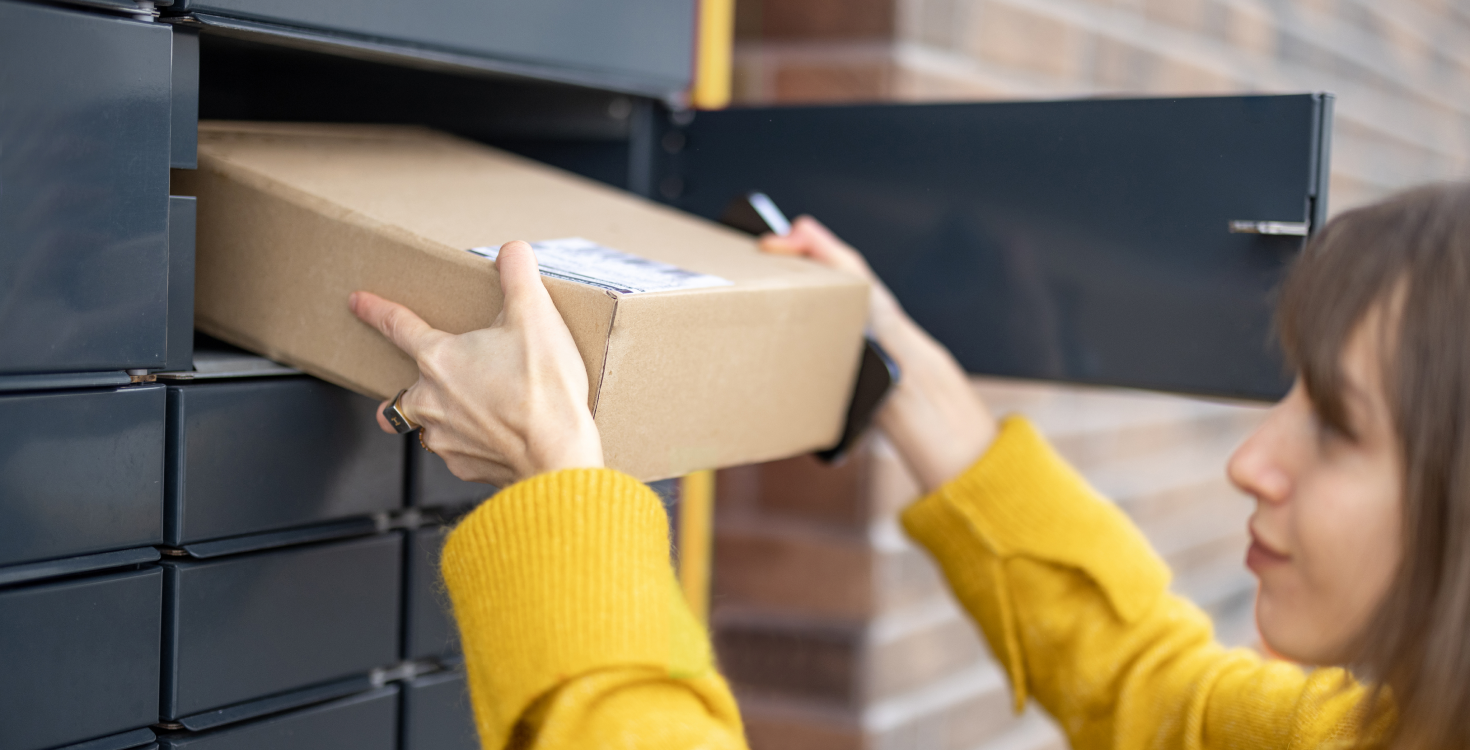 A woman collecting a parcel from an out-of-home collection point.
